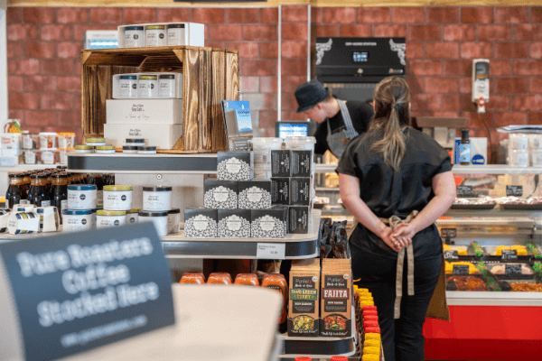 Staff member in the farm shop waiting to assist customers