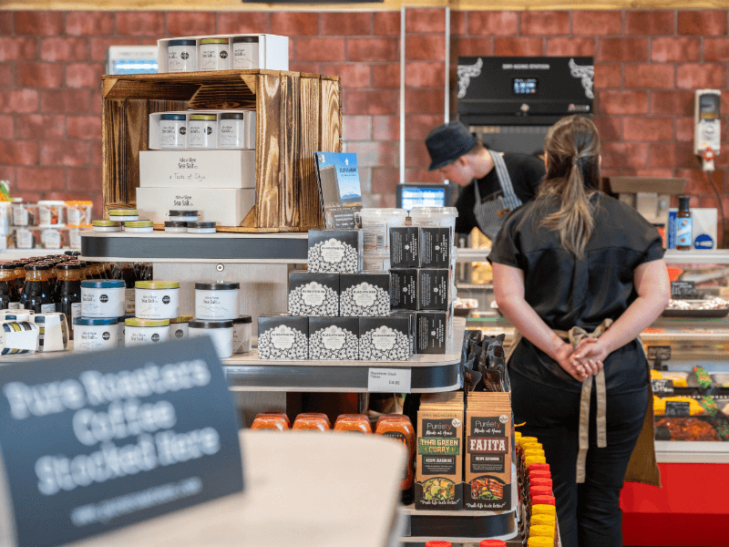 Staff member standing in the farm shop ready to assist customers